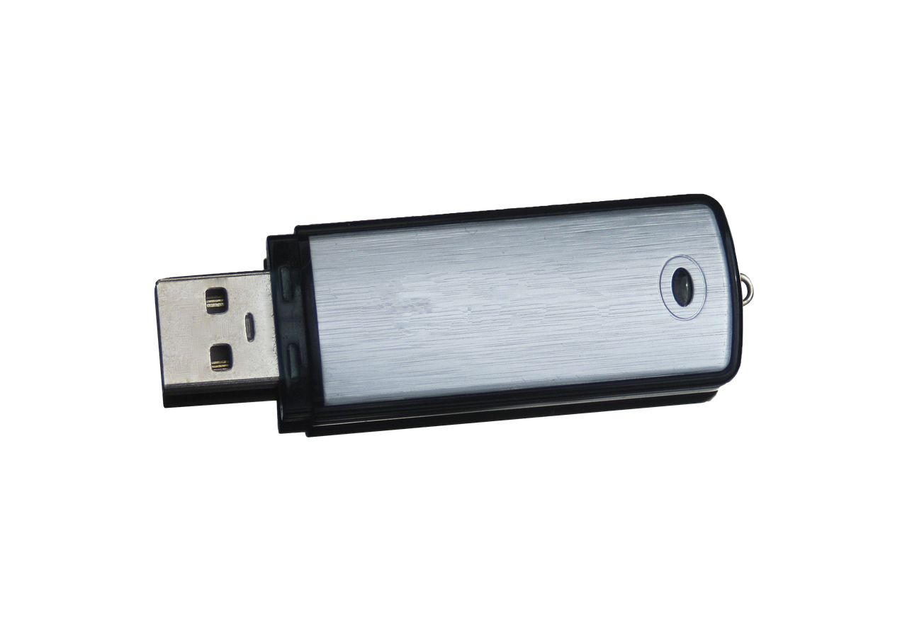 A single silver USB flash drive isolated on a black background.
