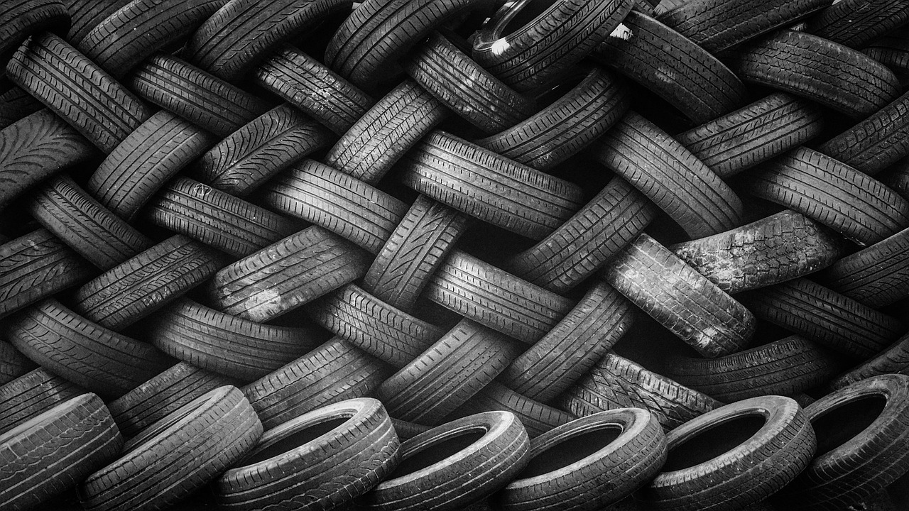A large wall made of stacked black rubber car tires.